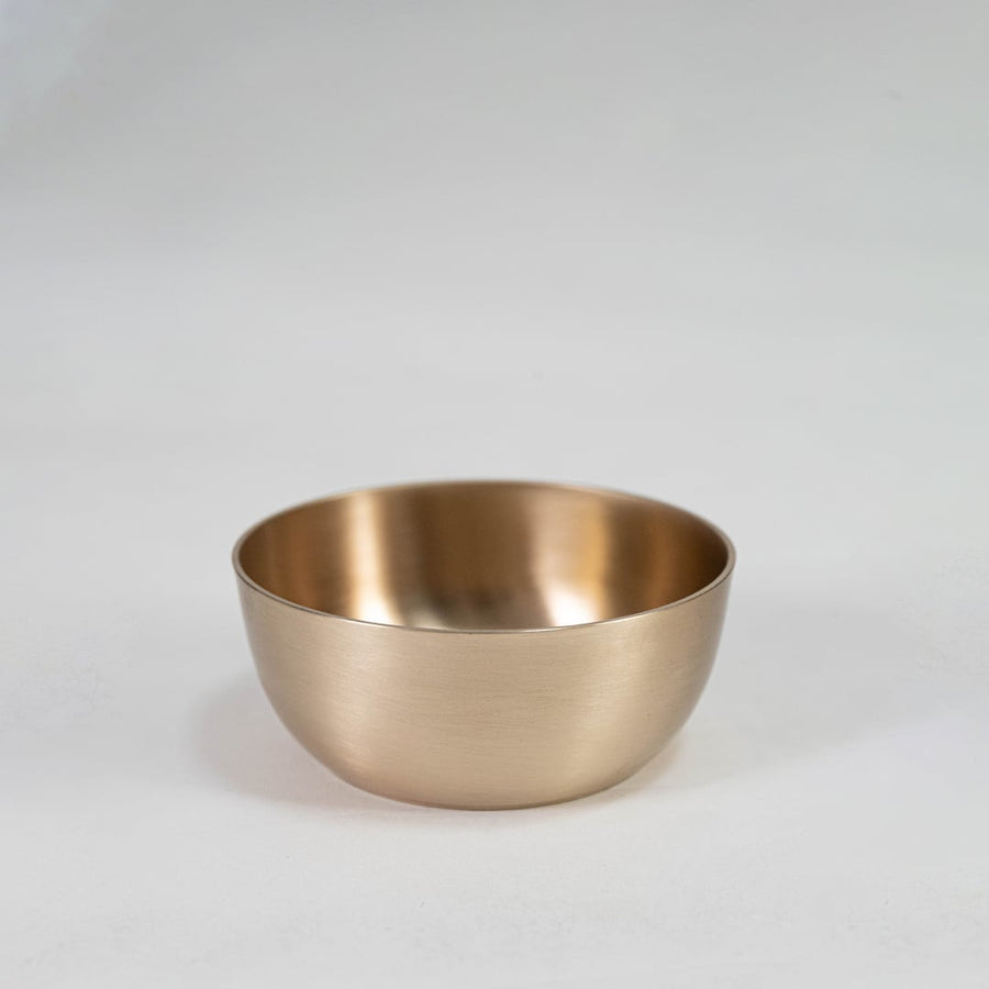 Plain brass tumbler with cylindrical shape and matte metallic finish displayed upright on clean white background.