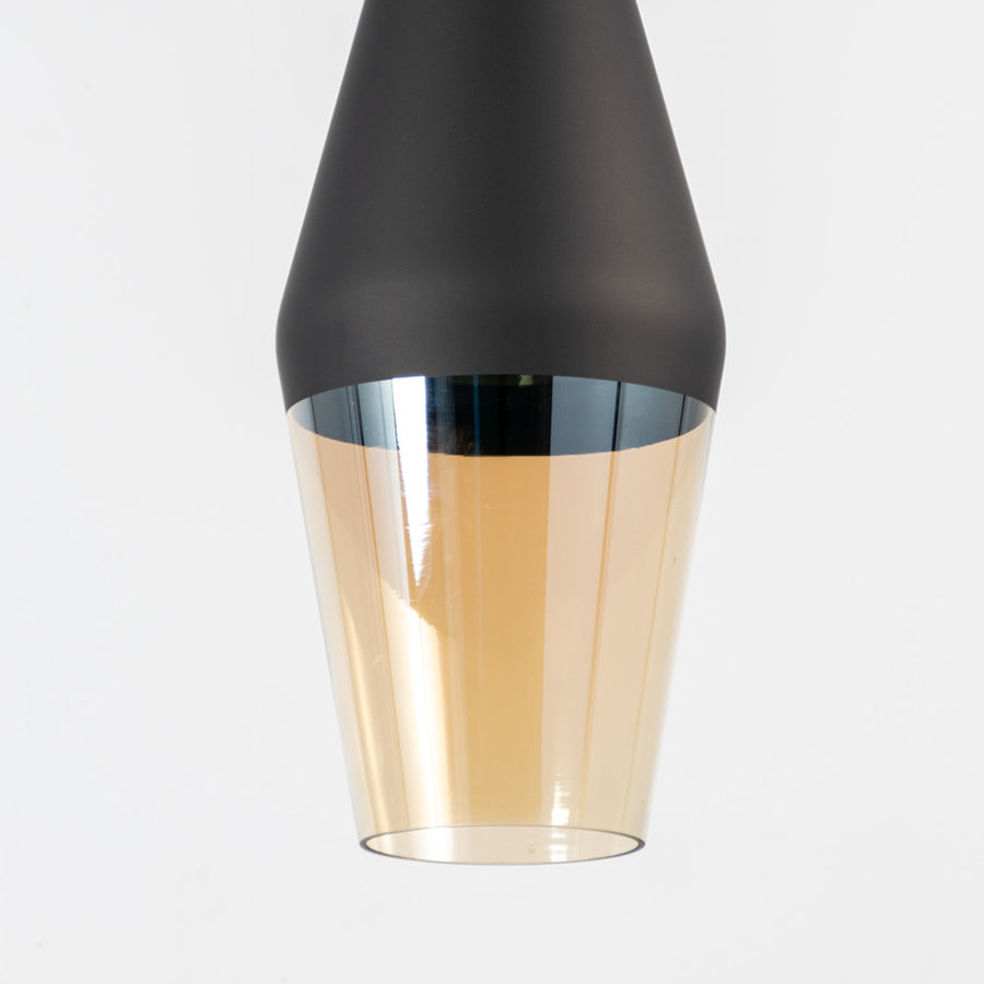 Amber glass pendant light with black metal shade showcasing smooth glossy finish and refined contemporary craftsmanship.