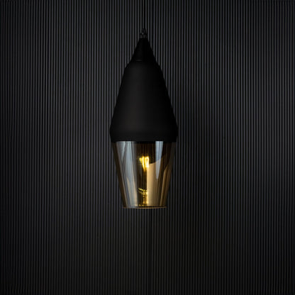 Pendant light turned on against a black background with warm illumination glowing through the amber glass shade emphasizing the elegant contrast and modern style.