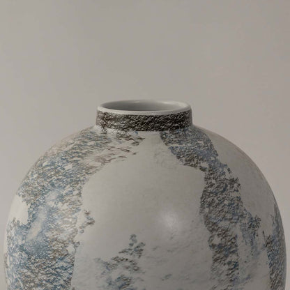 White ceramic decorative vase closeup highlighting blue floral pattern hand painted detailing and smooth glazed surface for elegant home decor.