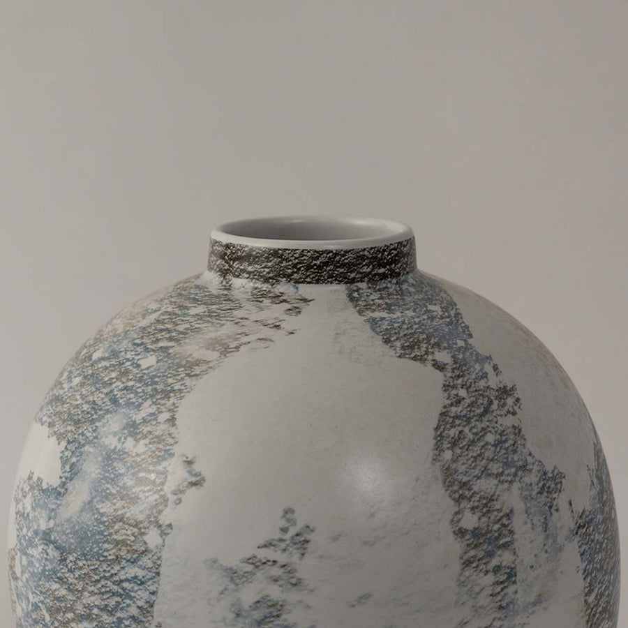 White ceramic decorative vase closeup highlighting blue floral pattern hand painted detailing and smooth glazed surface for elegant home decor.