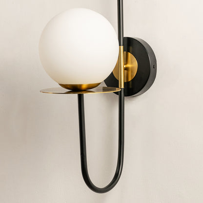 Modern wall light with white glass globe and black metal frame perfect for contemporary interior wall decor on clean background.