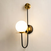 Modern black and gold wall light with white glass globe for elegant hallway and luxury decor styling spaces.