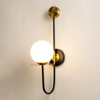 Modern black and gold wall light with white glass globe for elegant hallway and luxury decor styling spaces.