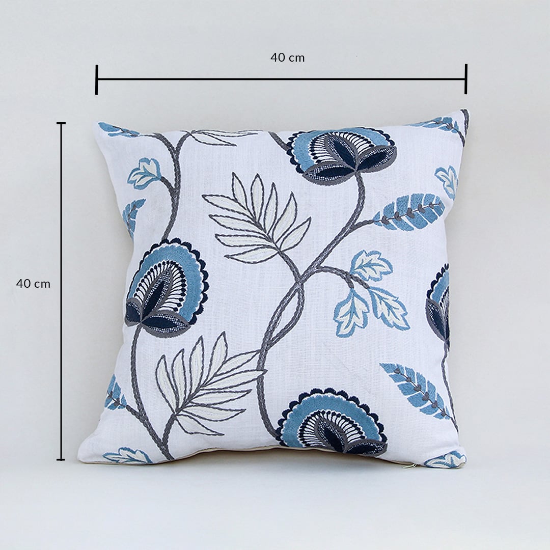 Soft cotton cushion cover with blue floral embroidery displayed with dimensions of 40 cm by 40 cm creating a cool nature inspired décor accent with a breathable gentle and skin friendly fabric.