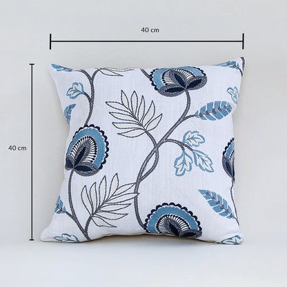 Soft cotton cushion cover with blue floral embroidery displayed with dimensions of 40 cm by 40 cm creating a cool nature inspired décor accent with a breathable gentle and skin friendly fabric.