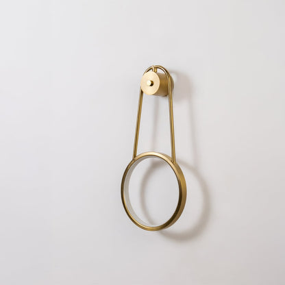 Gold metal ring wall light shown switched off on white background for minimal stylish home decor.