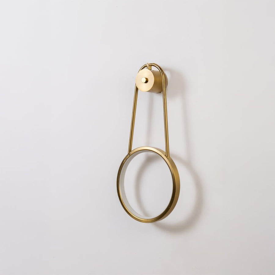 Gold metal ring wall light shown switched off on white background for minimal stylish home decor.