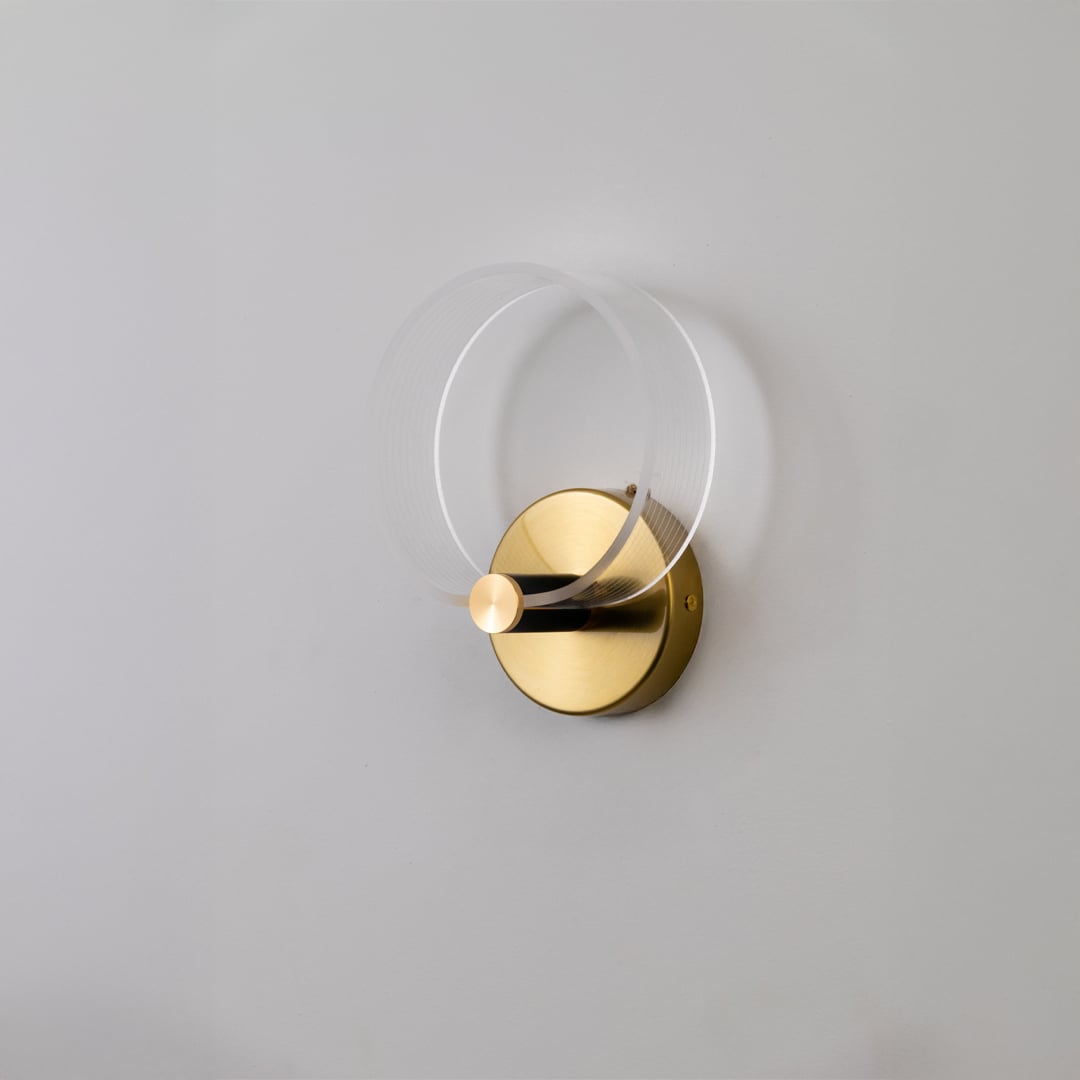 Gold metal wall light with frosted acrylic ring shown switched off on white background for clean minimal decor styling.