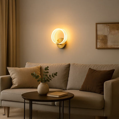 Modern gold metal wall light with frosted acrylic ring styled in a minimal room adding soft warm glow for elegant wall decor.