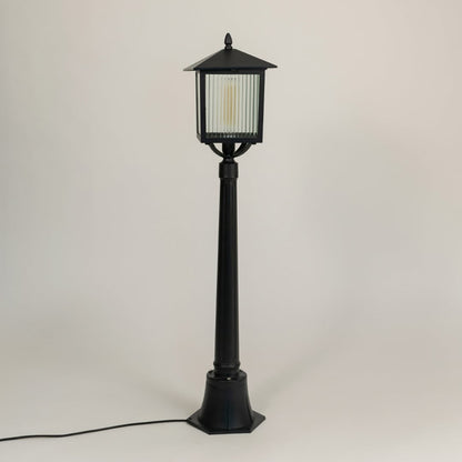 A tall outdoor lamp post with the light off shown on a white background emphasizing its sleek black finish and structured lantern design for detailed viewing.