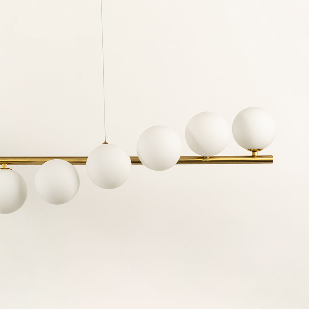 Frosted glass globe chandelier with gold metal frame highlighting premium materials and contemporary ceiling lighting design.