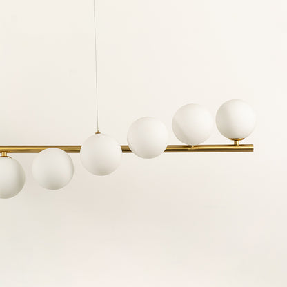 Frosted glass globe chandelier with gold metal frame highlighting premium materials and contemporary ceiling lighting design.
