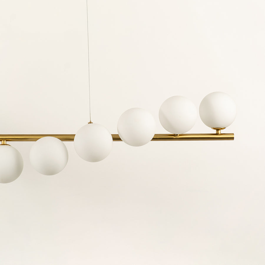 Frosted glass globe chandelier with gold metal frame highlighting premium materials and contemporary ceiling lighting design.