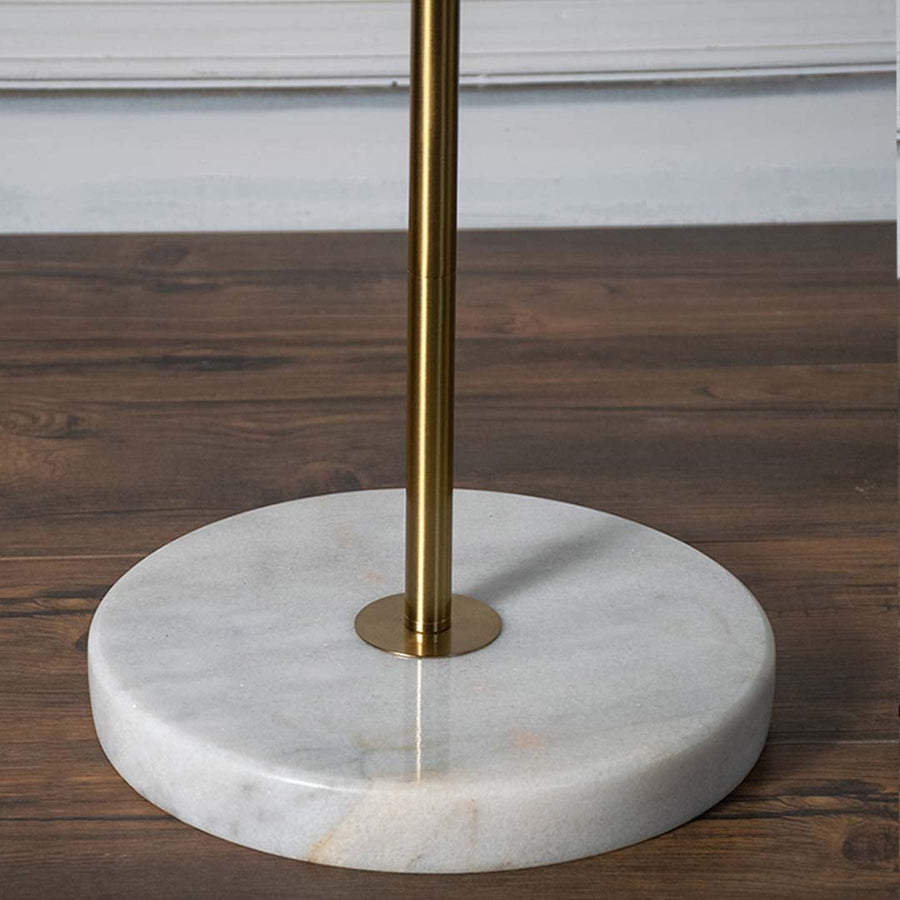Detailed view of gold floor lamp shade and light fixture showing modern and stylish finish.