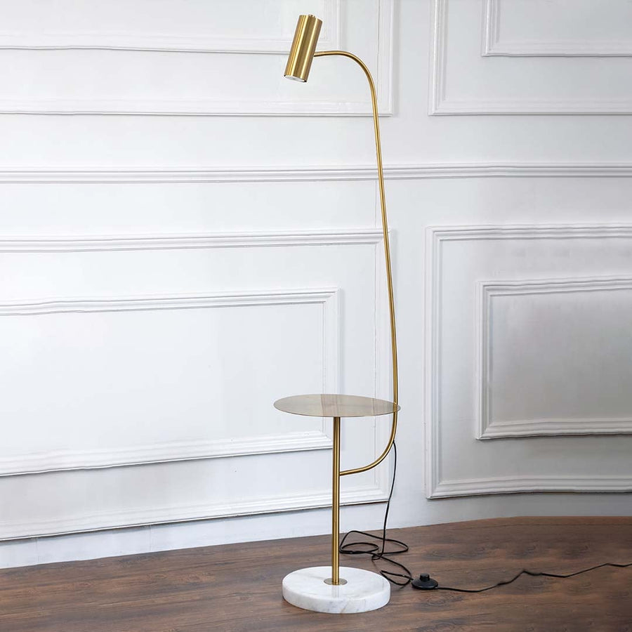 Gold floor lamp with side table and marble base photographed on white background with light turned on for product display.