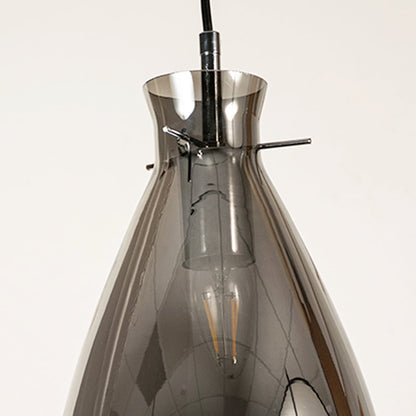 Close view of smoked chrome pendant light showing smooth glass texture elegant curve and polished reflective craftsmanship.