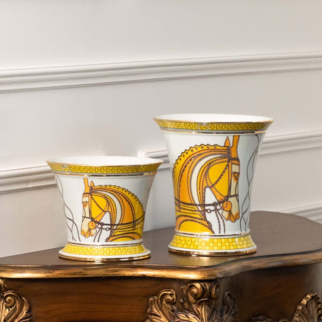 Yellow and white ceramic jars with curved patterns placed on a wooden console table adding a stylish décor accent that enhances modern interior styling well.