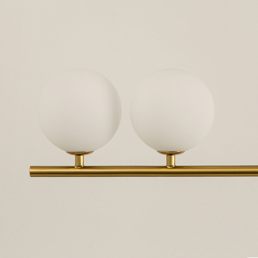 Frosted glass globe chandelier with gold metal frame showcasing elegant craftsmanship and modern decorative lighting.