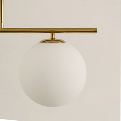 Frosted glass globe shade with gold metal bar detail highlighting premium materials and contemporary lighting design.