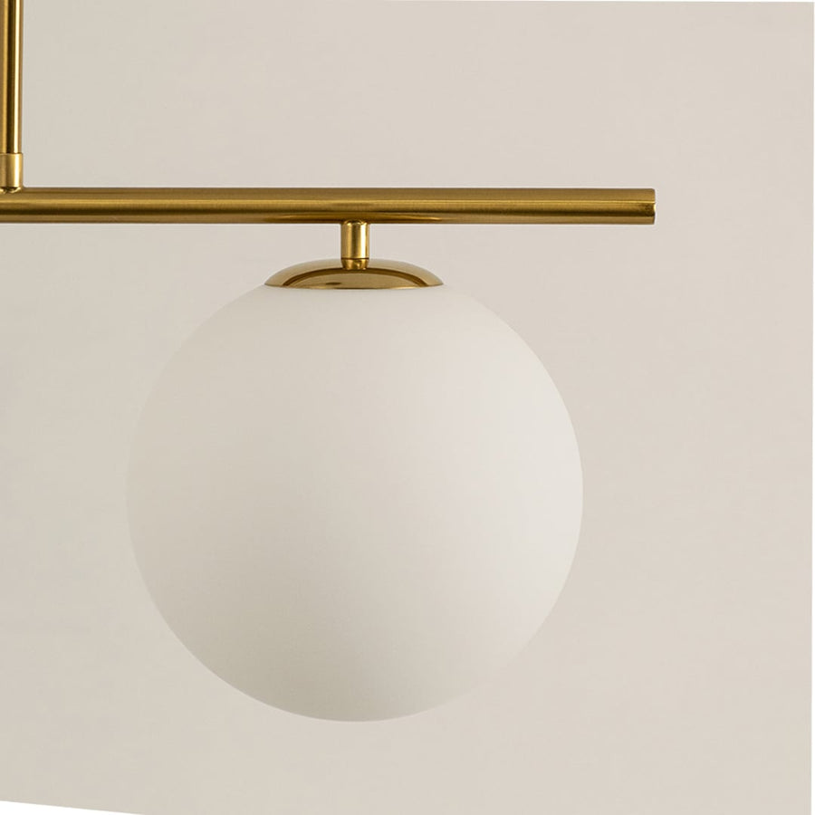 Frosted glass globe shade with gold metal bar detail highlighting premium materials and contemporary lighting design.