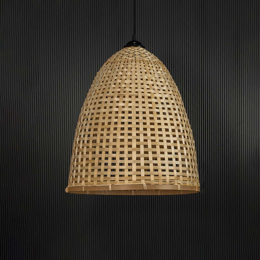 Bamboo pendant light bulb off on black background with handwoven tall dome wicker shade for natural home lighting.