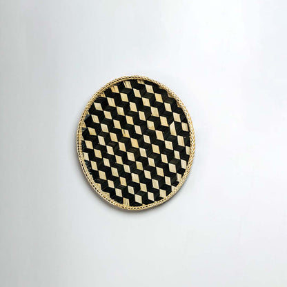 Side view of woven bamboo basket tray showing depth and handcrafted construction detail with black geometric pattern design.