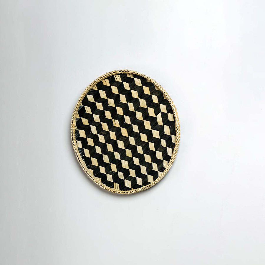 Side view of woven bamboo basket tray showing depth and handcrafted construction detail with black geometric pattern design.