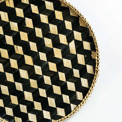 Closeup of handwoven bamboo basket showing intricate black and natural checkered weave pattern and artisan craftsmanship.