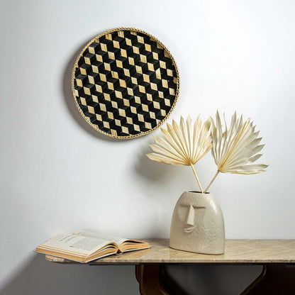 Bamboo woven wall basket with geometric black pattern creating modern boho texture accent in minimalist interior design.