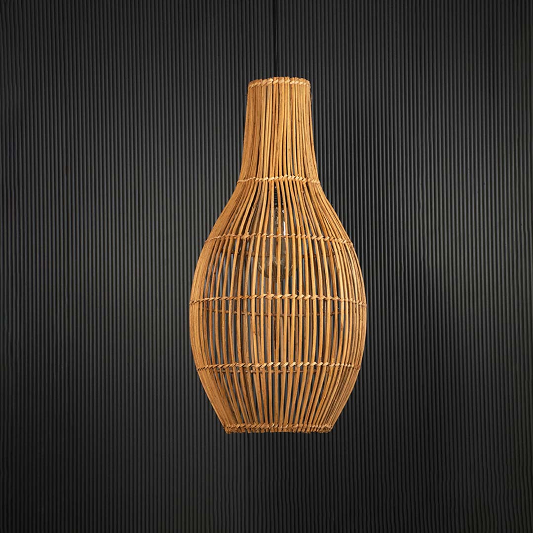 Natural rattan pendant lamp against black background showing handcrafted texture and shape.