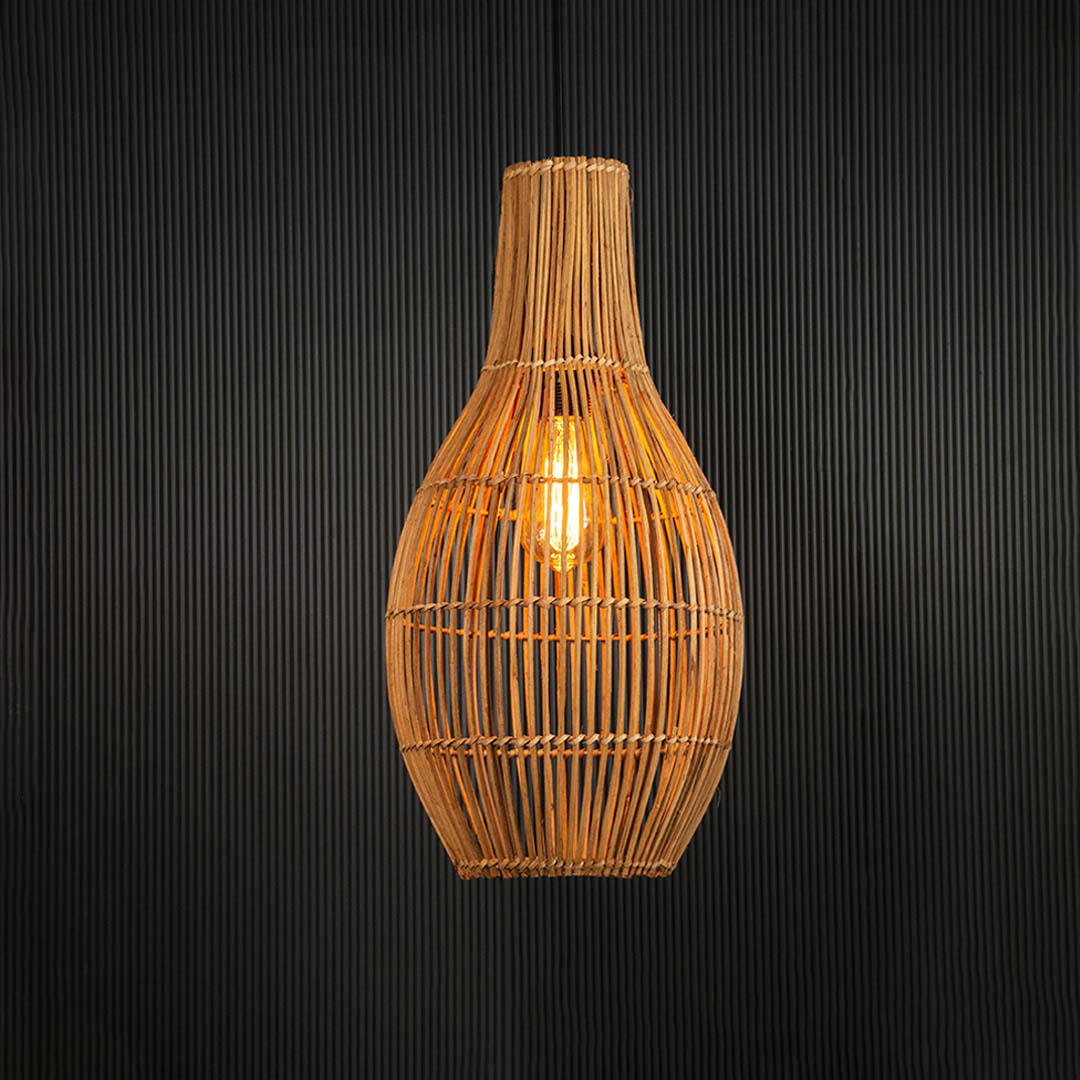 Warm glowing rattan pendant lamp suspended on black background adding cozy ambient lighting.