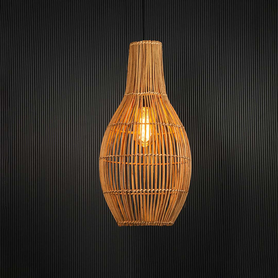 Warm glowing rattan pendant lamp suspended on black background adding cozy ambient lighting.
