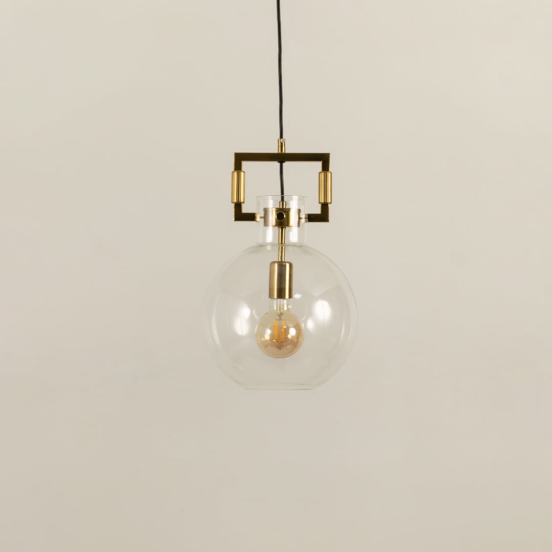 Glass globe pendant light with gold metal detailing shown with light off on a white background emphasizing its sleek minimalist look.