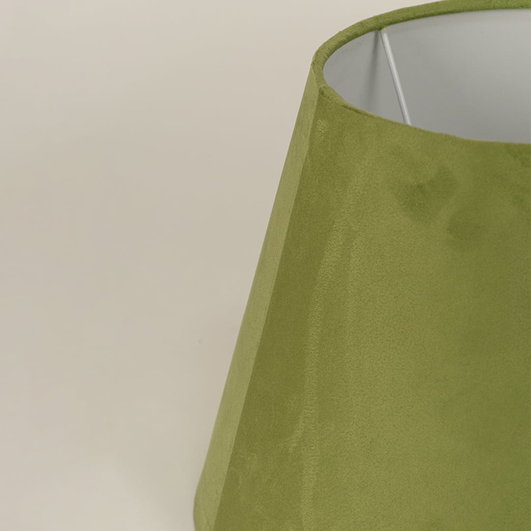 Closeup of green velvet lampshade showing soft textured fabric smooth curves and refined modern craftsmanship.