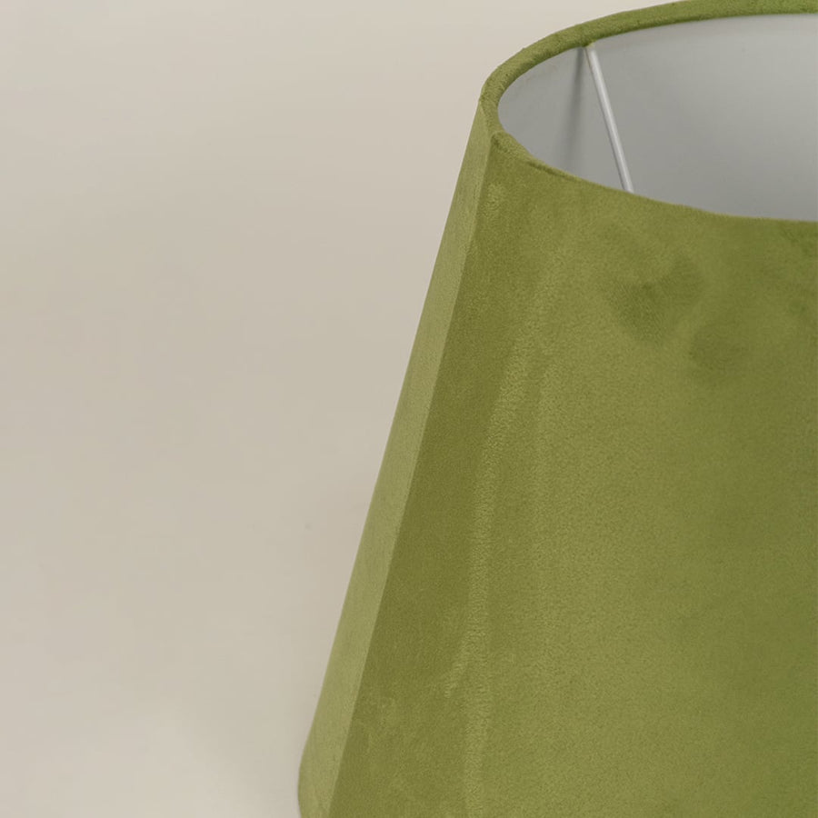 Closeup of green velvet lampshade showing soft textured fabric smooth curves and refined modern craftsmanship.