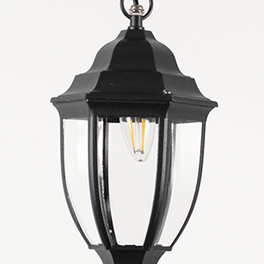 Contemporary black metal hanging lantern light with curved clear glass and sleek frame for patio decor.