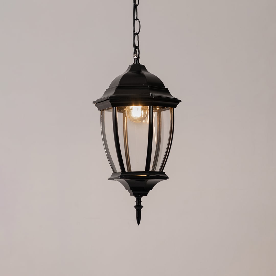 Modern black metal hanging lantern light with warm glow for elegant balcony and patio lighting.
