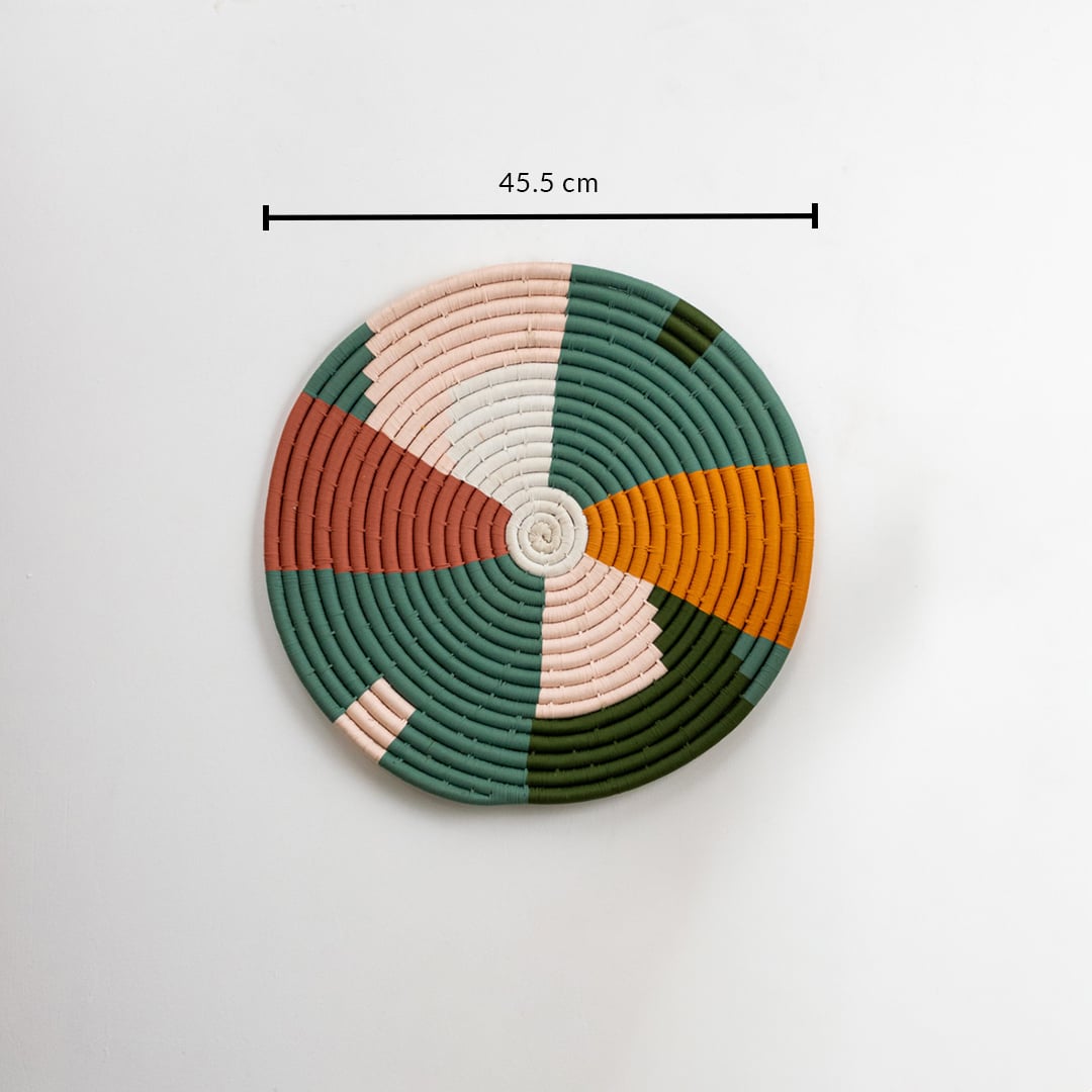 Round woven wall decor in green mustard peach and cream tones on a white background showing its full size clearly marked as 45 point 5 cm diameter.