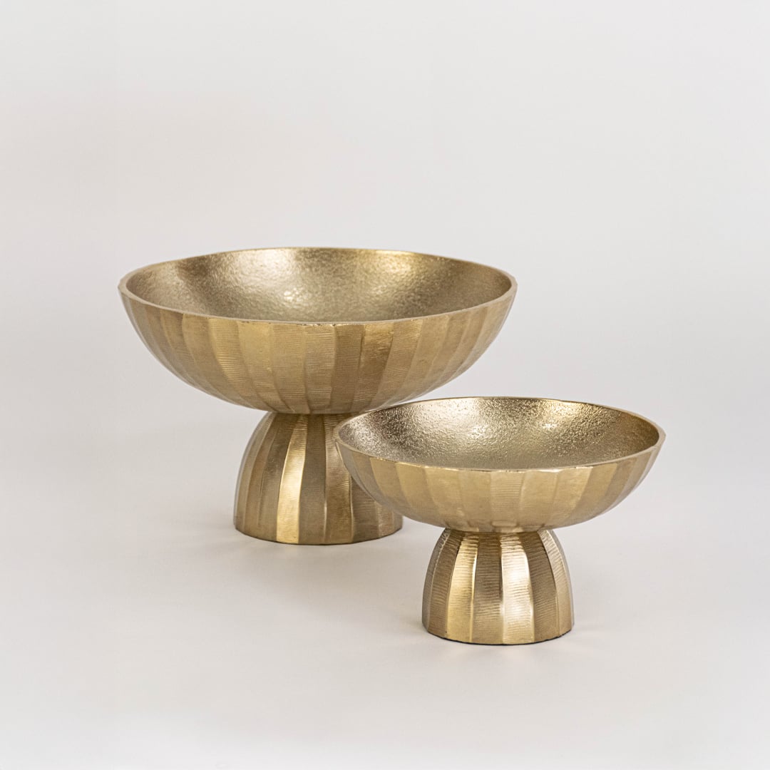 Modern gold metal bowl with deep form and fluted base displayed clearly on white background for product showcase