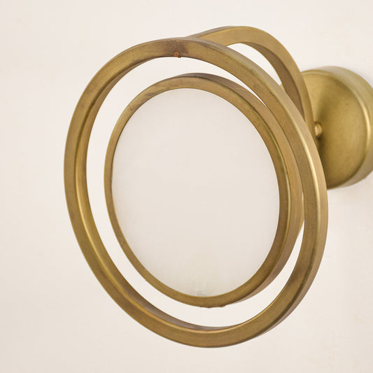 Closeup of gold metal ring wall light for modern hallway and premium decor styling spaces.

