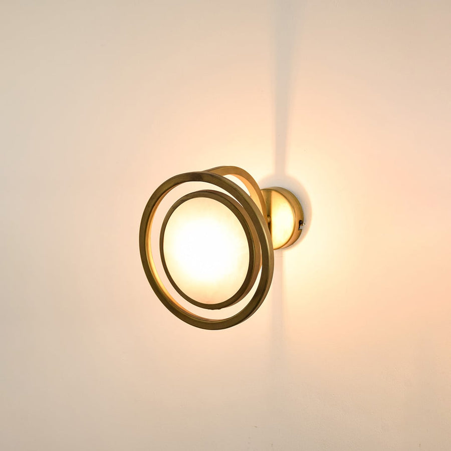 Modern gold ring wall light with warm glow for elegant hallway and luxury decor styling spaces.