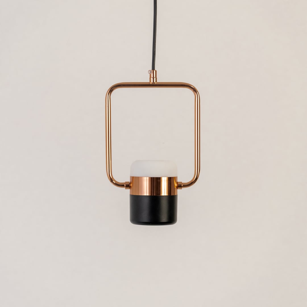 Rose gold pendant light with black and white diffuser displayed on white background for stylish living room and dining decor.
