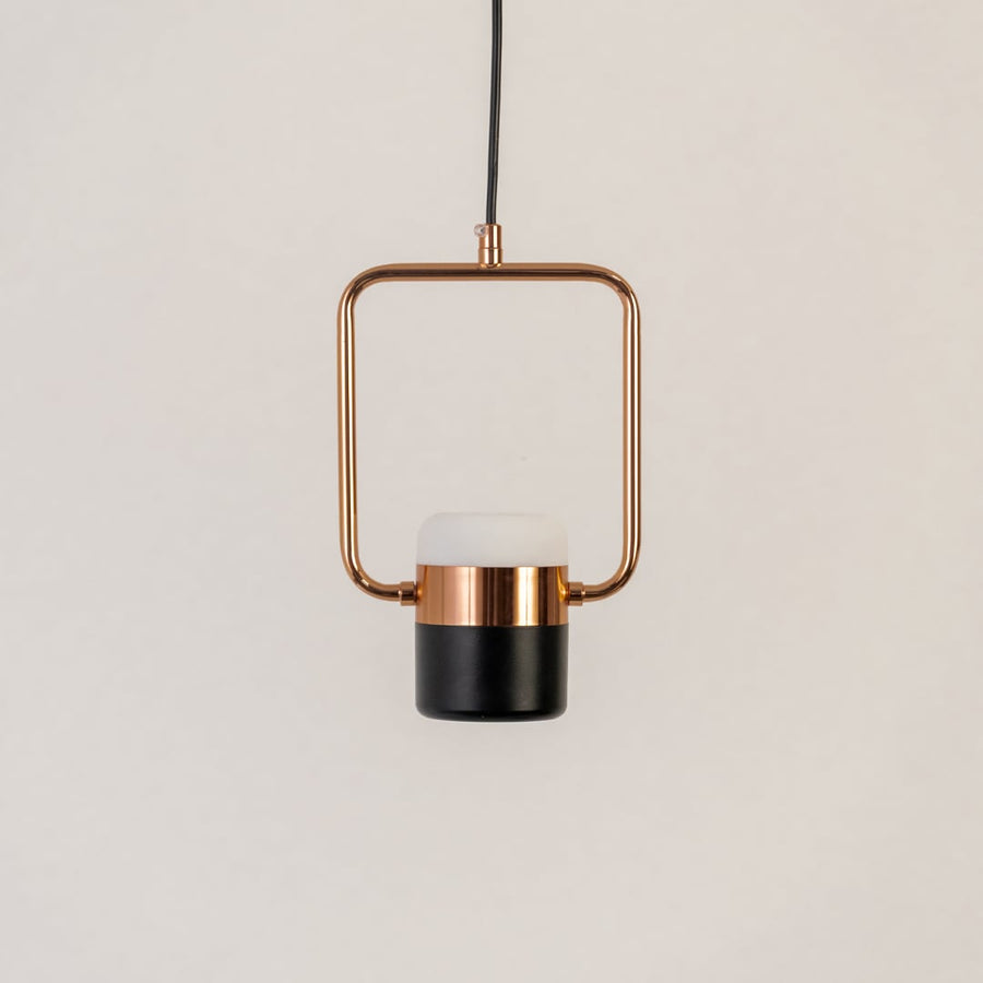Rose gold pendant light with black and white diffuser displayed on white background for stylish living room and dining decor.