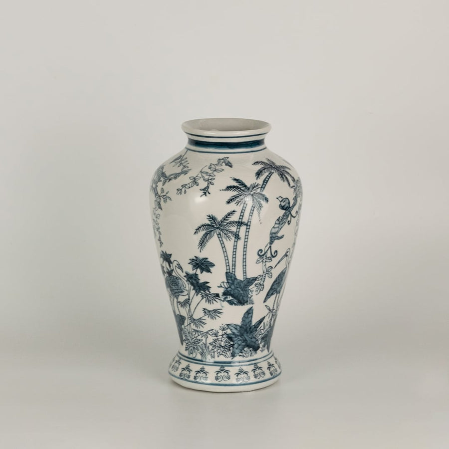 Blue and white ceramic jar featuring detailed landscape artwork with birds and trees shown on a plain surface creating a refined timeless decorative accent for interior spaces.