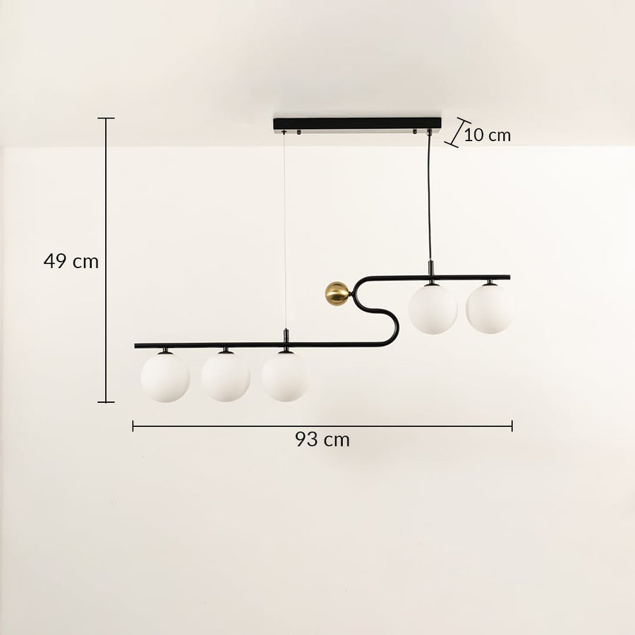 A sculptural black linear chandelier with four glowing white globes measuring 49 cm height and 93 cm width displayed on a clean white backdrop adding stylish warm décor.