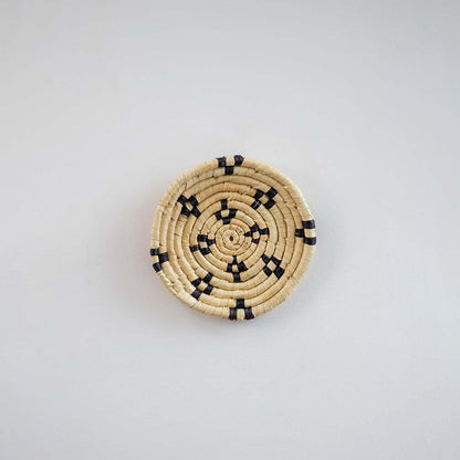 Natural handcrafted woven wall basket with black tribal pattern for elegant wall styling and modern home decor.