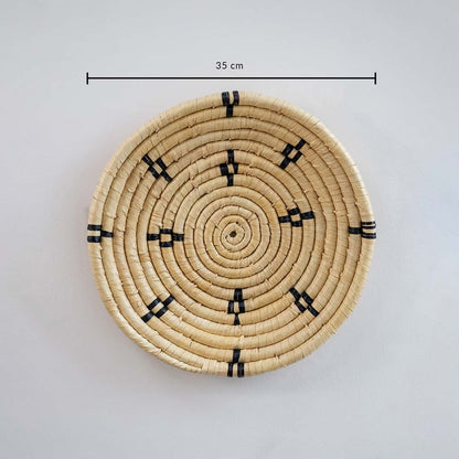 Natural fiber round wall basket with geometric detailing showing approx 28 cm diameter for interior wall decor arrangement.