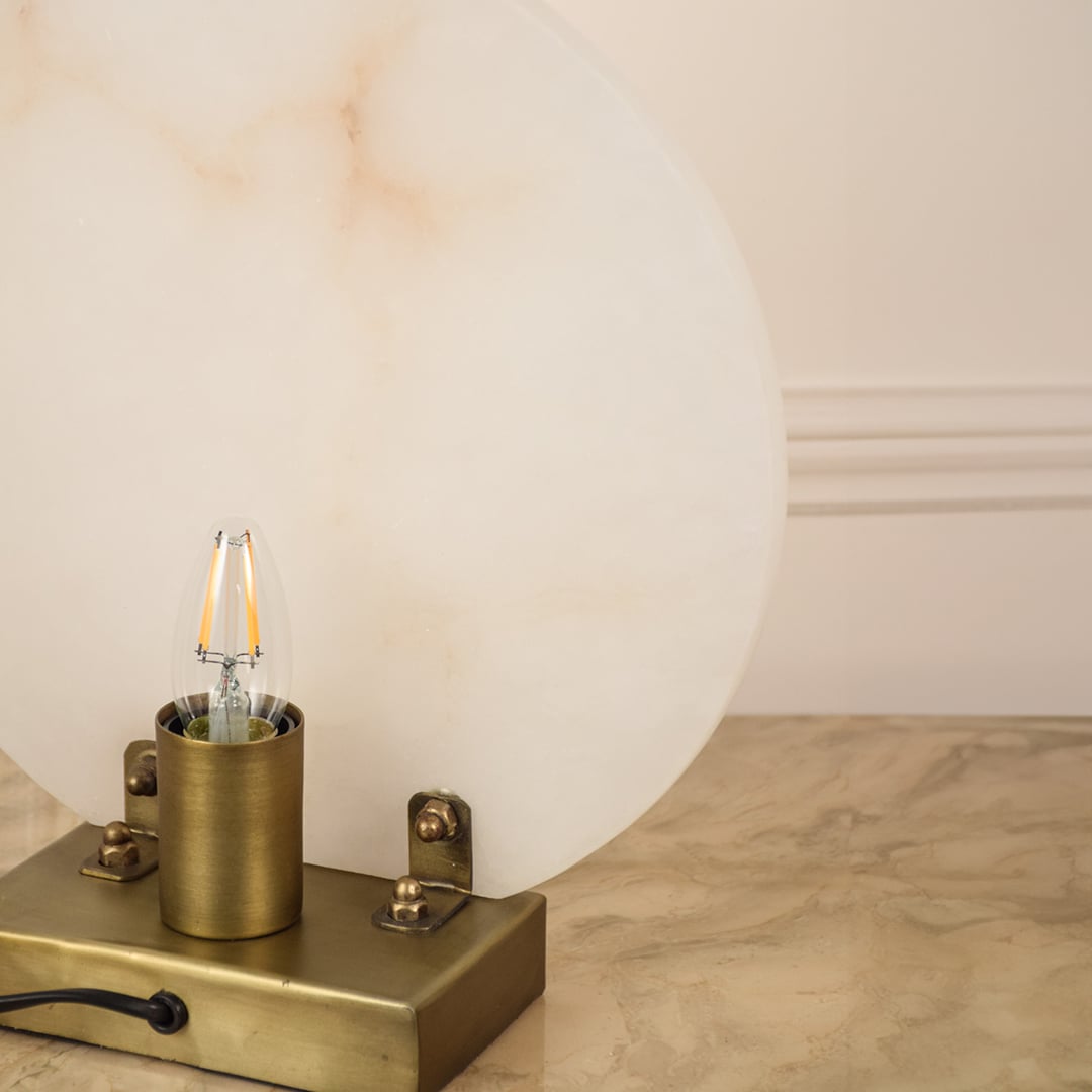 Closeup of marble table lamp showing smooth natural veining and polished metal base emphasizing craftsmanship and premium design.