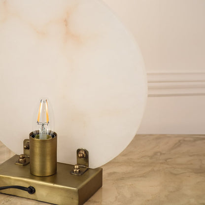 Closeup of marble table lamp showing smooth natural veining and polished metal base emphasizing craftsmanship and premium design.